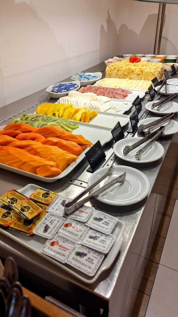 A buffet with various food items and condiments.