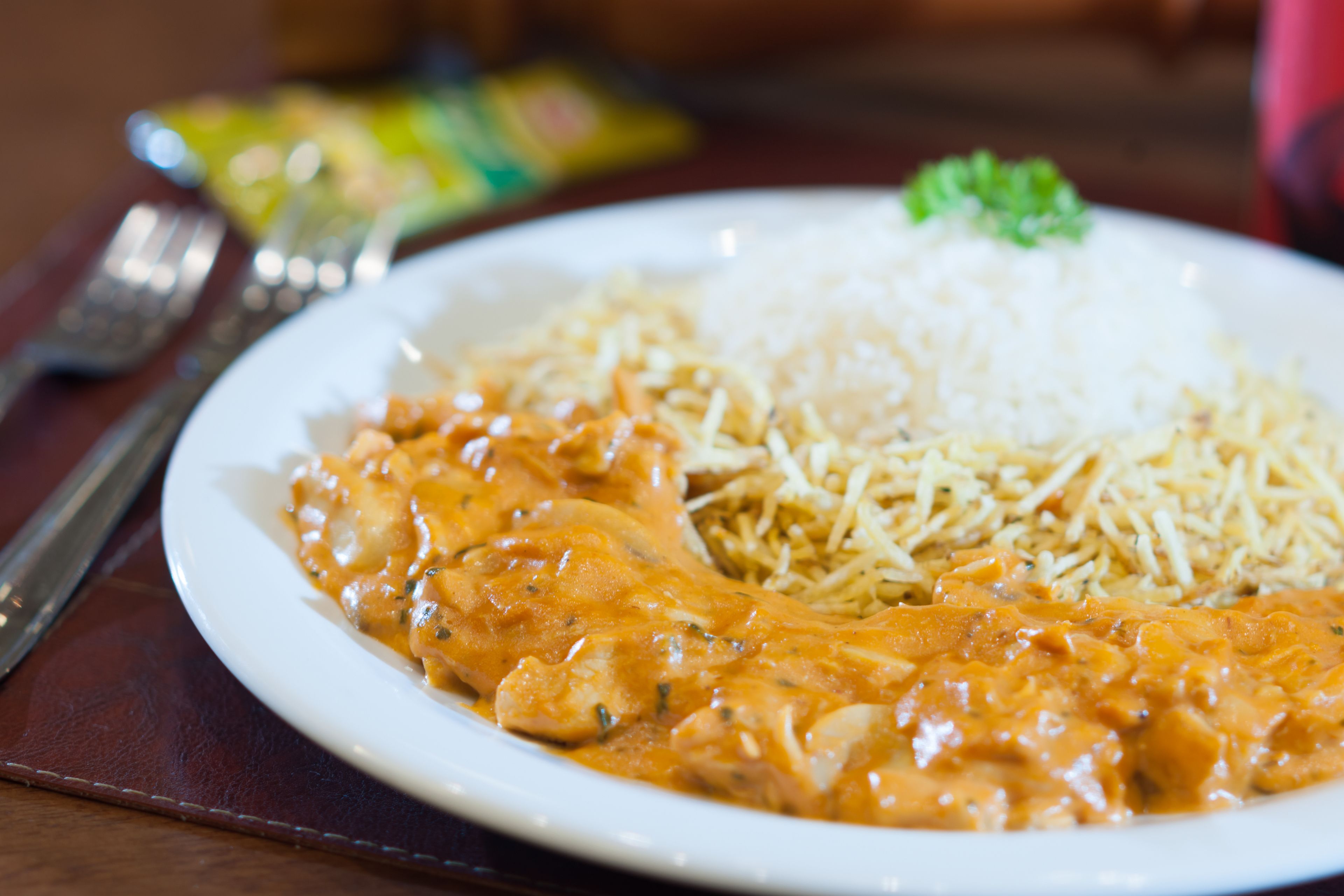 A plate of food with rice and a creamy sauce.