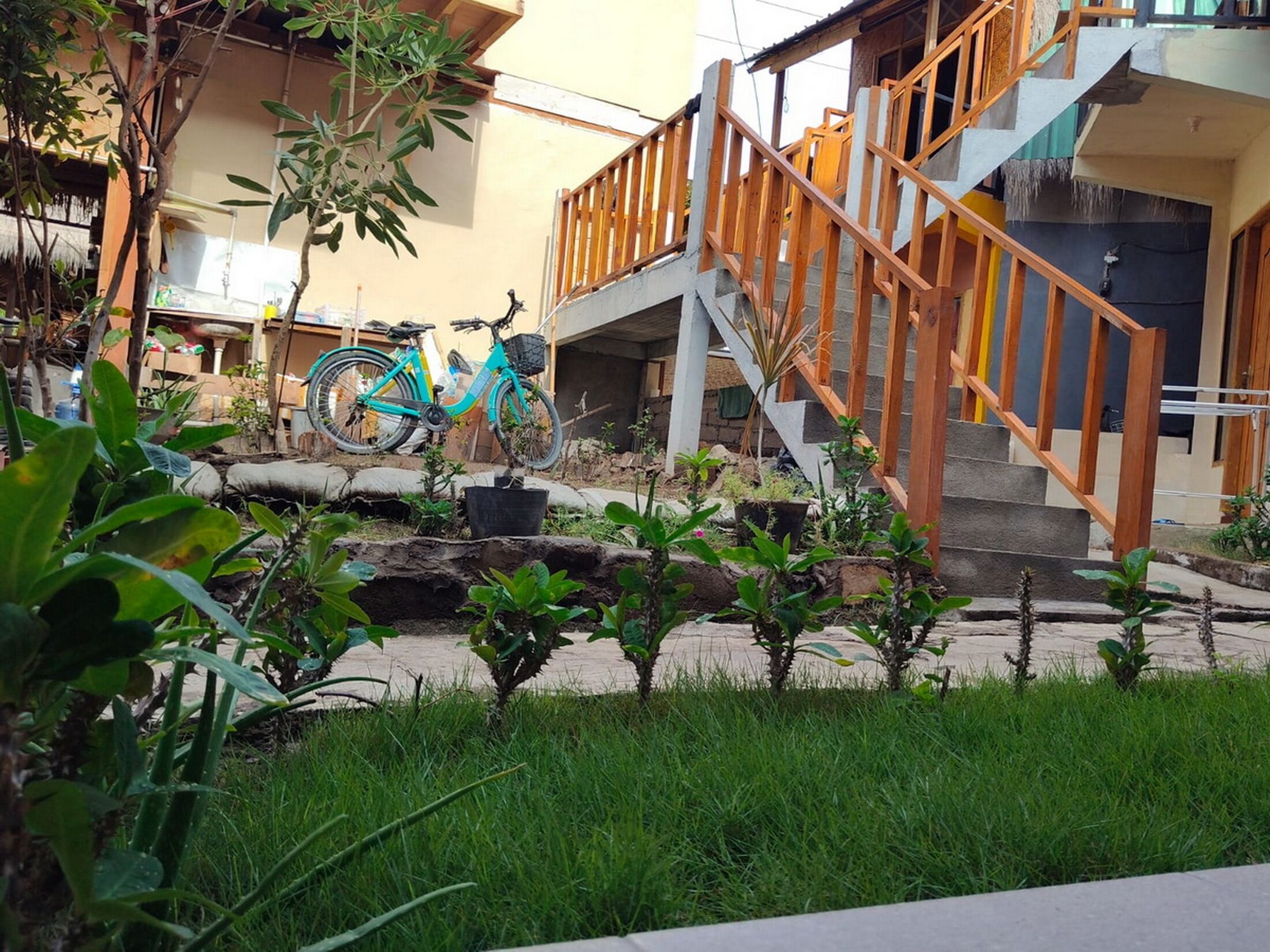 A staircase with wooden railings leading to a building entrance.