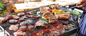 A grill with various meats and vegetables being cooked. - Garden Villa - Pattaya Holiday House Walking Street (Pattaya)