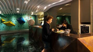 A modern reception area with a curved ceiling, a reception desk, and a wall with decorative elements.