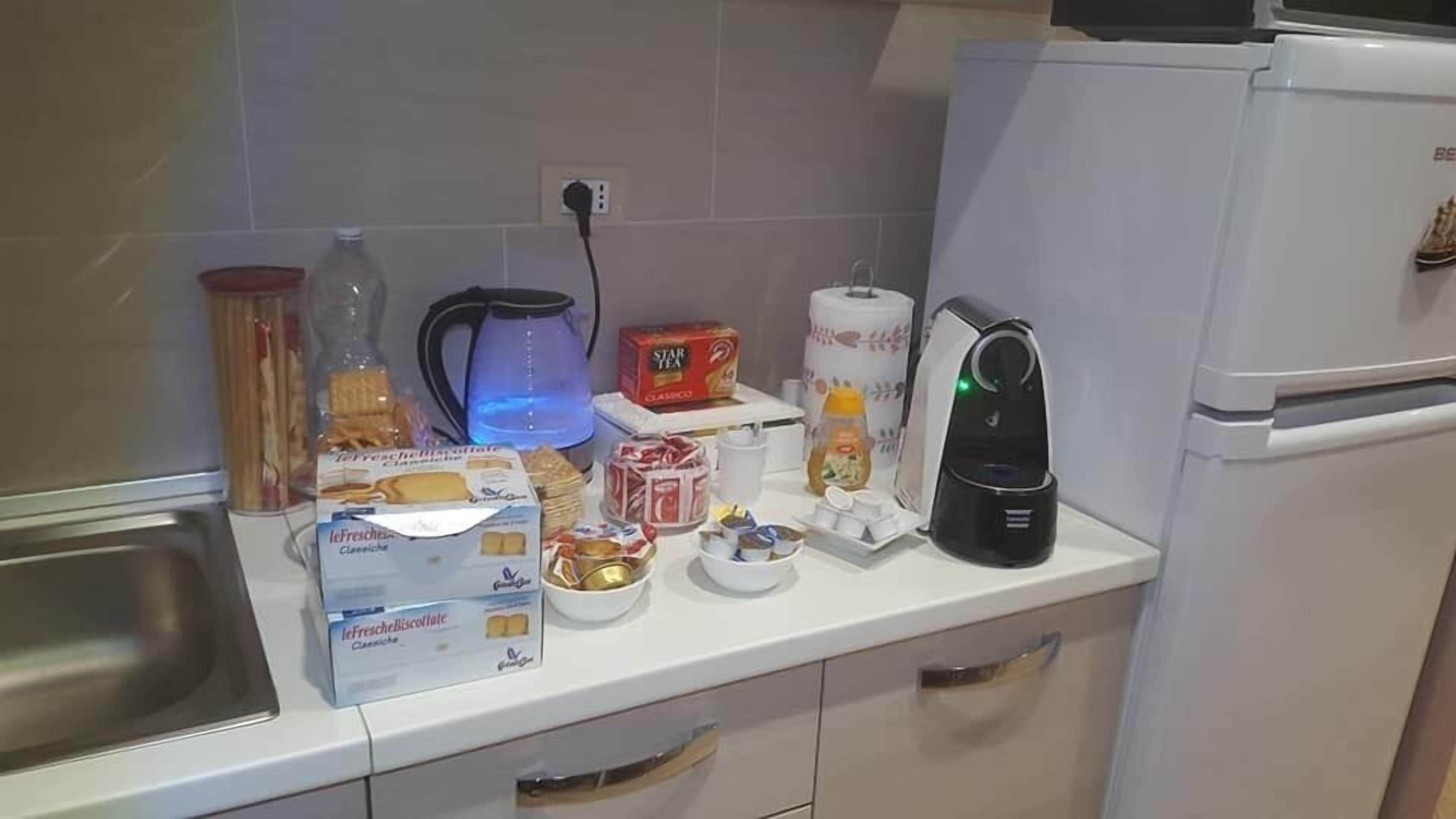 Fridge, electric kettle, cookware/dishes/utensils