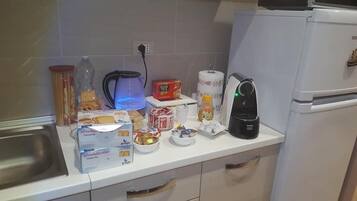 Fridge, electric kettle, cookware/dishes/utensils