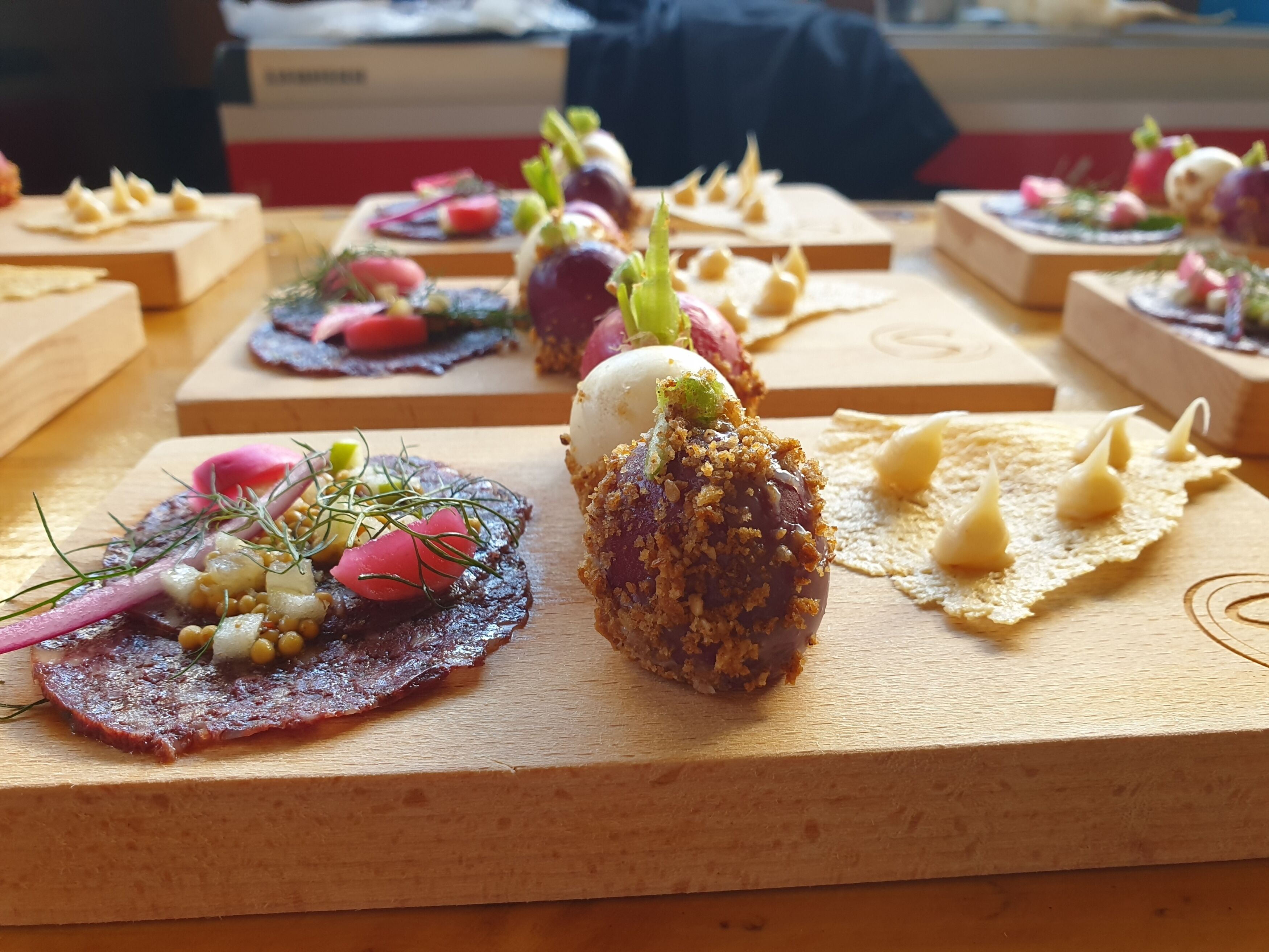 A variety of gourmet appetizers arranged on wooden boards.