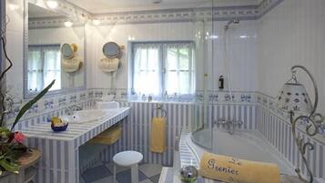 Deluxe Room | Bathroom | Designer toiletries, hair dryer, towels