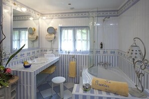 Deluxe Room | Bathroom | Designer toiletries, hair dryer, towels