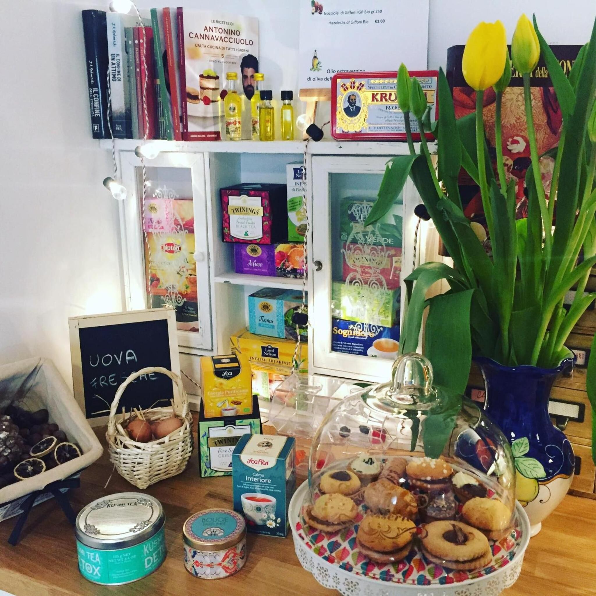 A kitchen counter with various food items, tea, and books.