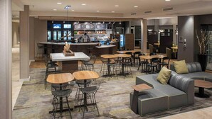 A modern hotel lobby with a bar area, seating arrangements, and a reception desk. - Courtyard by Marriott Albany Clifton Park (Clifton Park)