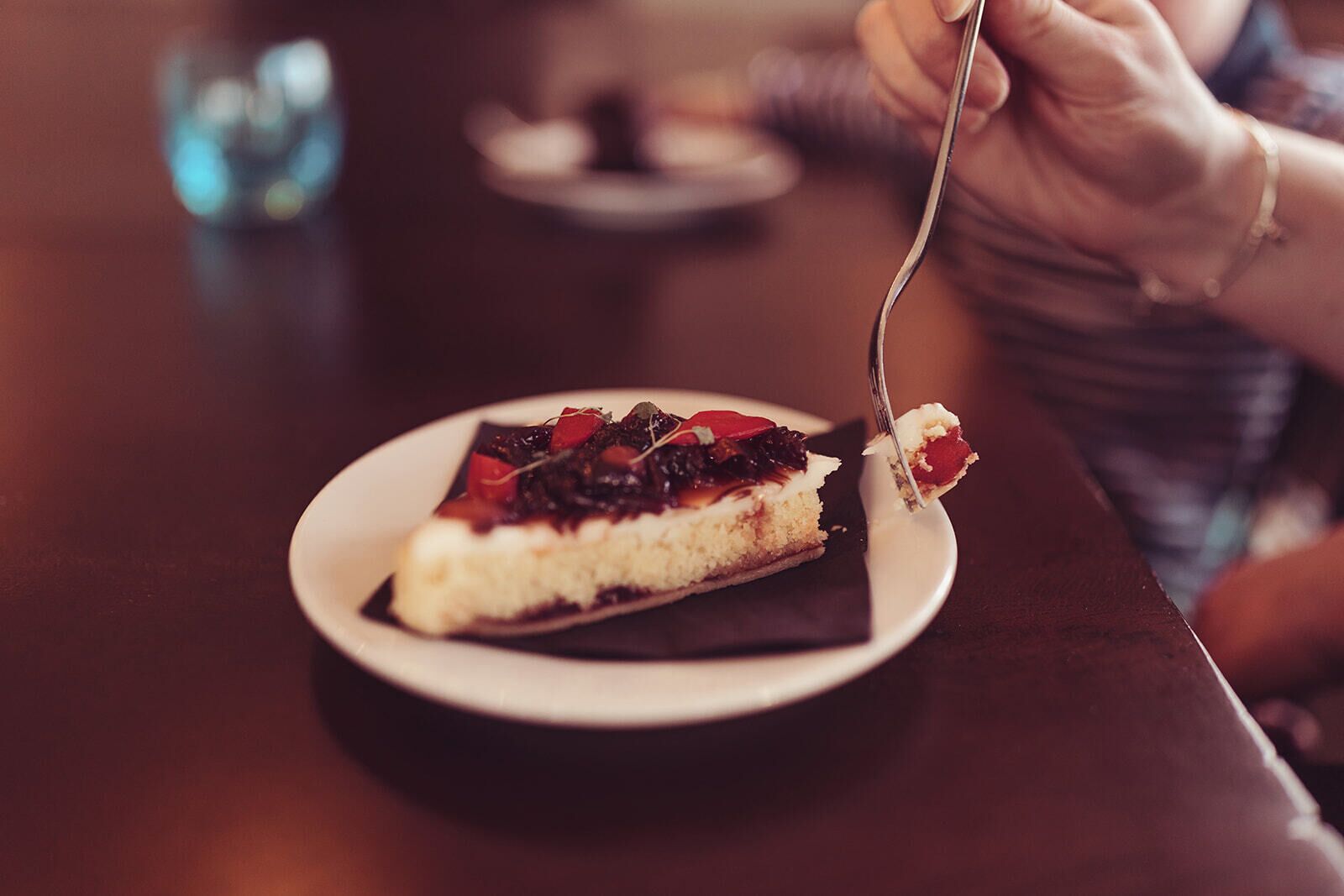 A slice of cake with a fork on a plate.