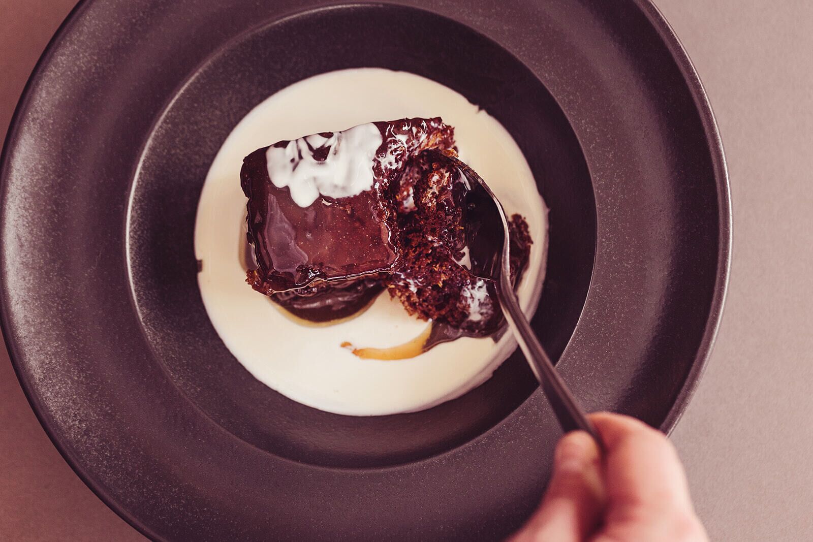 A dessert on a plate with a spoon.