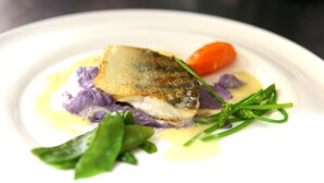 A plate with a piece of fish, purple vegetables, and a carrot. - Logis Auberge de la Treille (Saint-Martin-le-Beau)