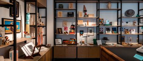 A well-organized office space with shelves displaying various items, a desk with a computer, and a chair.