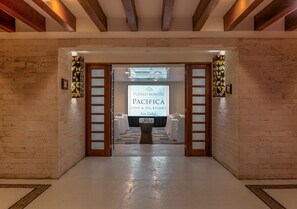 A lobby with a sign for Pueblo Bonito Pacifica Golf & Spa Resort in Los Cabos.