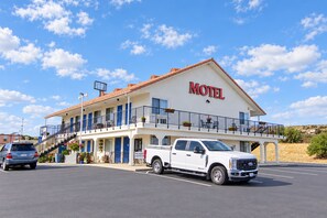 A motel with a two-story structure, a white exterior, and a sign that reads 'Motel' on the front. - Back Country Inn Boulevard, CA (Boulevard)