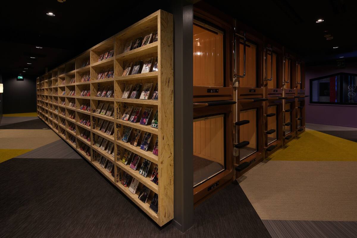 A library with wooden bookshelves filled with books.