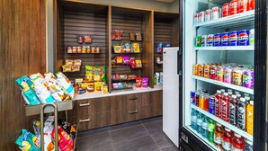 A snack and beverage vending area with various snacks and drinks.