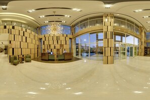 A spacious lobby with a reception desk, seating area, and large windows. - Fairfield By Marriott Lucknow (Lucknow)