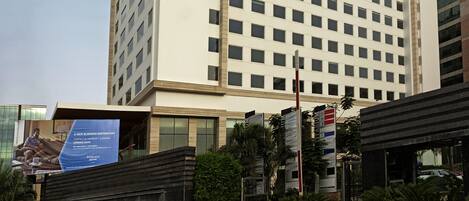 A tall, modern hotel building with a flat facade and numerous windows.