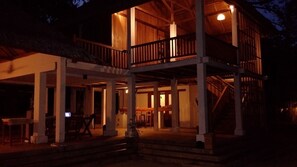 A multi-level wooden structure with a balcony, steps leading to the entrance, and a thatched roof visible in the background. - Jonaths Cottage Bunaken (Pulau Bunaken)
