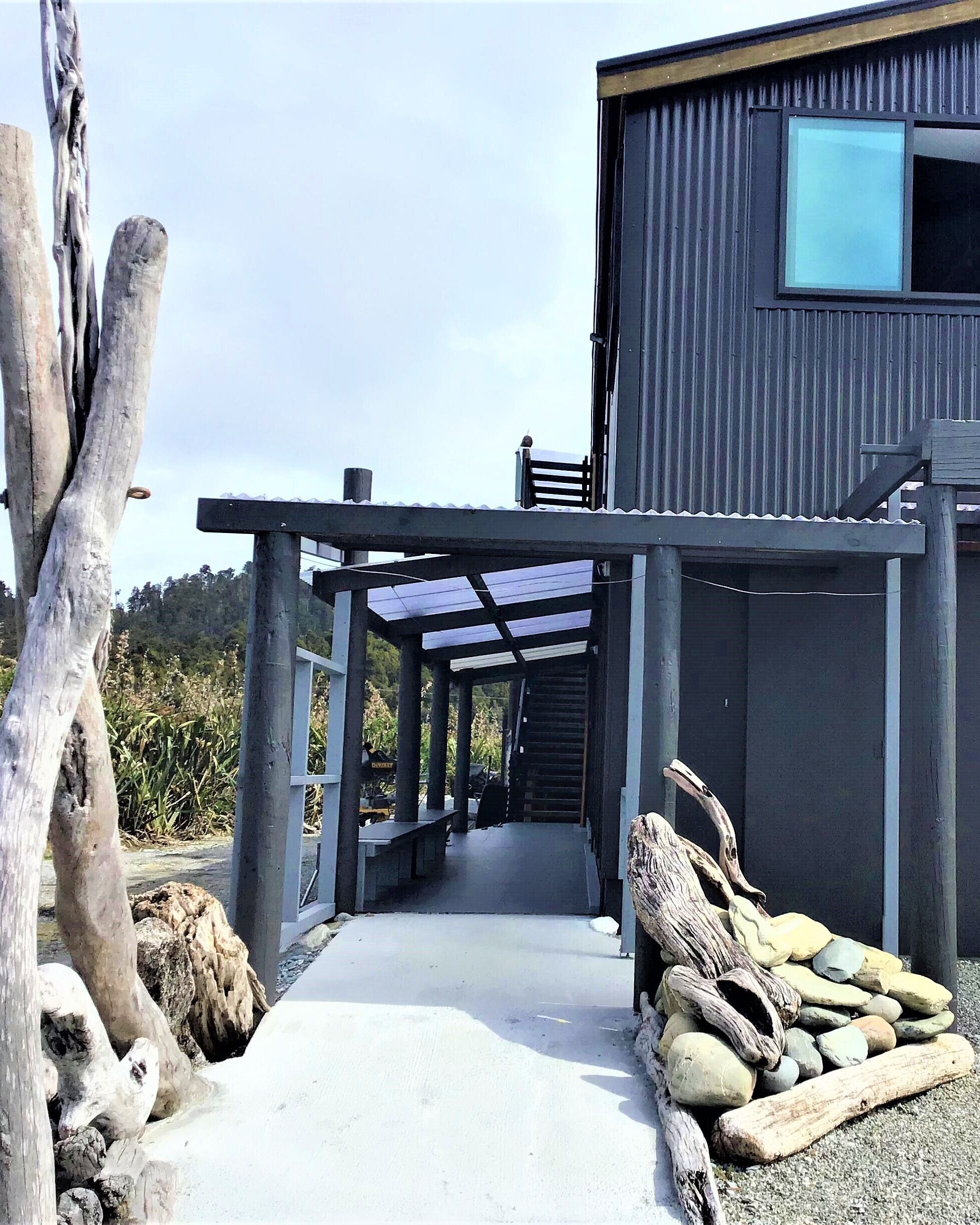 A modern building with a covered walkway leading to a door.