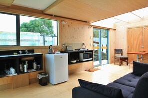 Black Sands Unit | Living area | Fireplace - Code Time Lodge (Okarito)