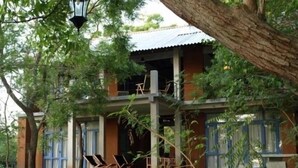 A two-story building with a balcony, surrounded by trees and vegetation. - Wapi Bungalowi Yala (Thissamaharama)