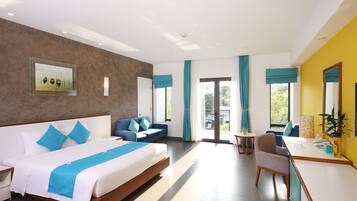 A modern hotel room with a large bed, a desk, and a balcony.