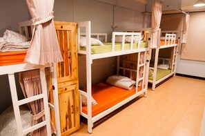 A room with bunk beds, wooden cabinets, and curtains. - Eat - Ting Cafe and Hostel (Bangkok)