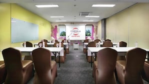 A conference room with tables and chairs, a whiteboard, and a presentation screen. - Cordela Kartika Dewi Jogjakarta (Yogyakarta)