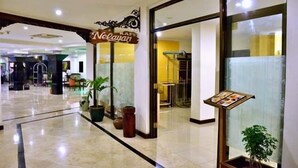 A hotel lobby with a sign for 'Neylan' and a reception desk. - Bahari Inn Tegal (Tegal)