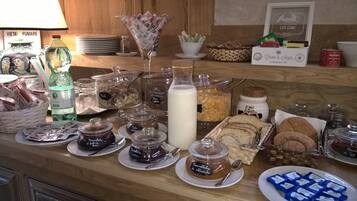 A breakfast buffet with various food items and condiments.