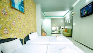 A hotel room with two beds, a TV on the wall, and a view into the adjacent room. - Yen Vy Hotel (Quy Nhon Nam)