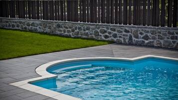 Seasonal outdoor pool, open 10:00 AM to 10:00 PM, pool loungers