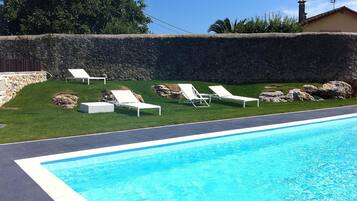 Seasonal outdoor pool, open 10:00 AM to 10:00 PM, pool loungers