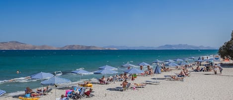 On the beach, sun loungers, beach umbrellas, beach bar