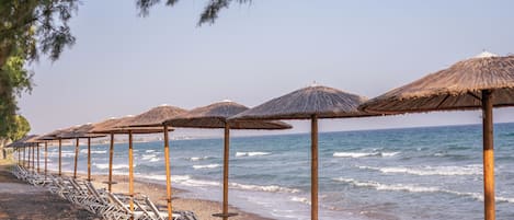 On the beach, sun-loungers, beach umbrellas, beach bar