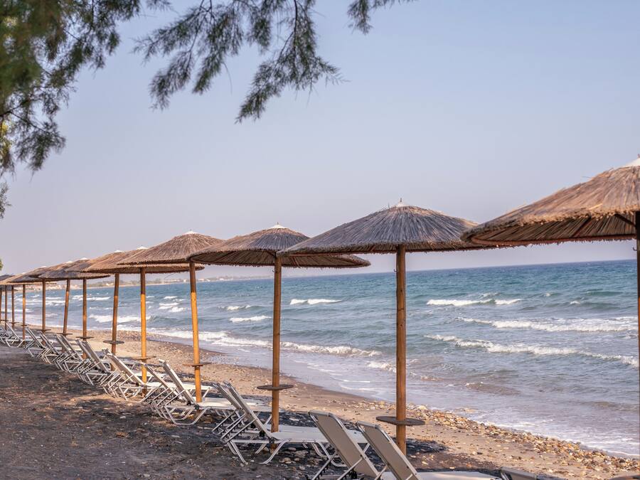 On the beach, sun-loungers, beach umbrellas, beach bar