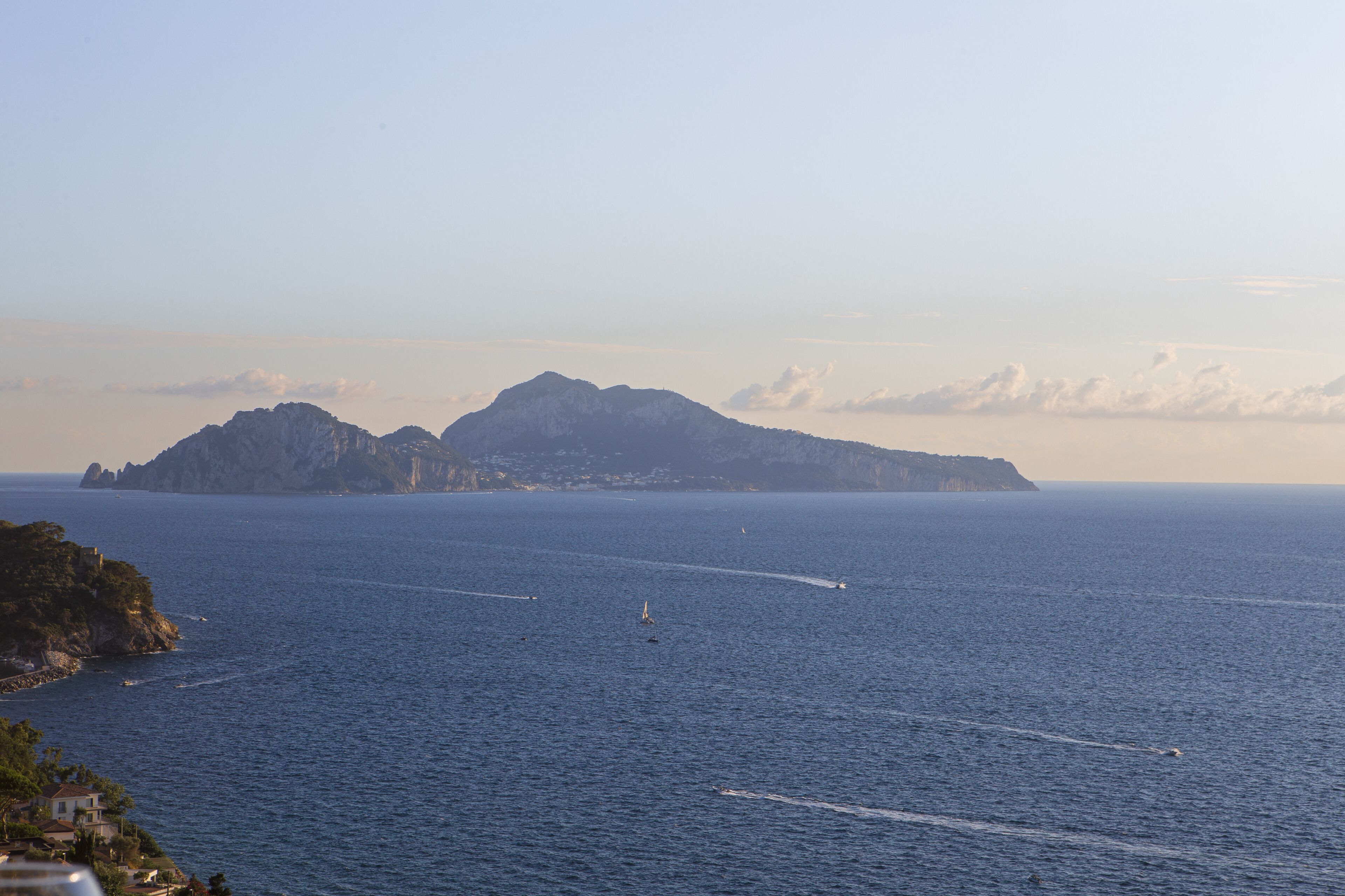 A coastal view with a prominent mountain and a clear sky.