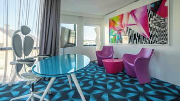 Signature Suite, 1 Queen Bed | Living area | 40-inch flat-screen TV with satellite channels, TV