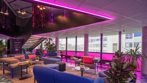 A modern lounge area with seating, plants, and a staircase. - Prize by Radisson, Solheimsviken Bergen (Bergen)