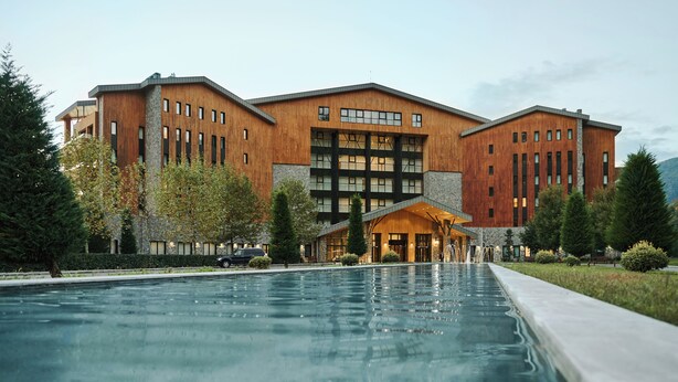A modern building with a pool in front. - Chenot Palace Gabala (Gabala)