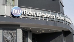 The exterior of Best Western Hotel with a prominent 'BW' logo and a modern architectural design.