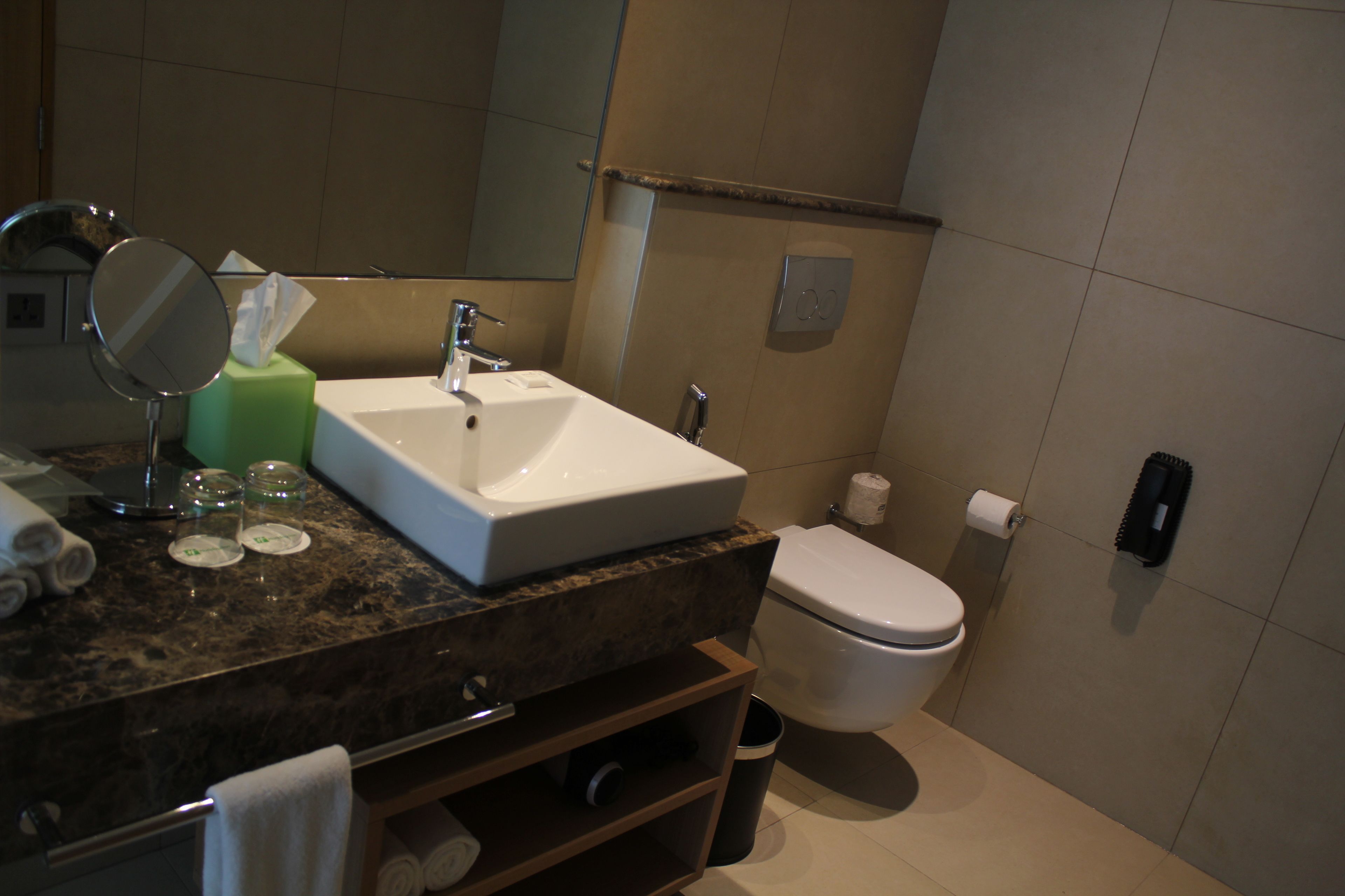 A bathroom with a sink, mirror, and toilet.