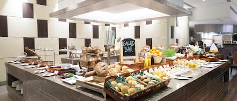 A buffet setup with various food items and a sign indicating a salad bar.