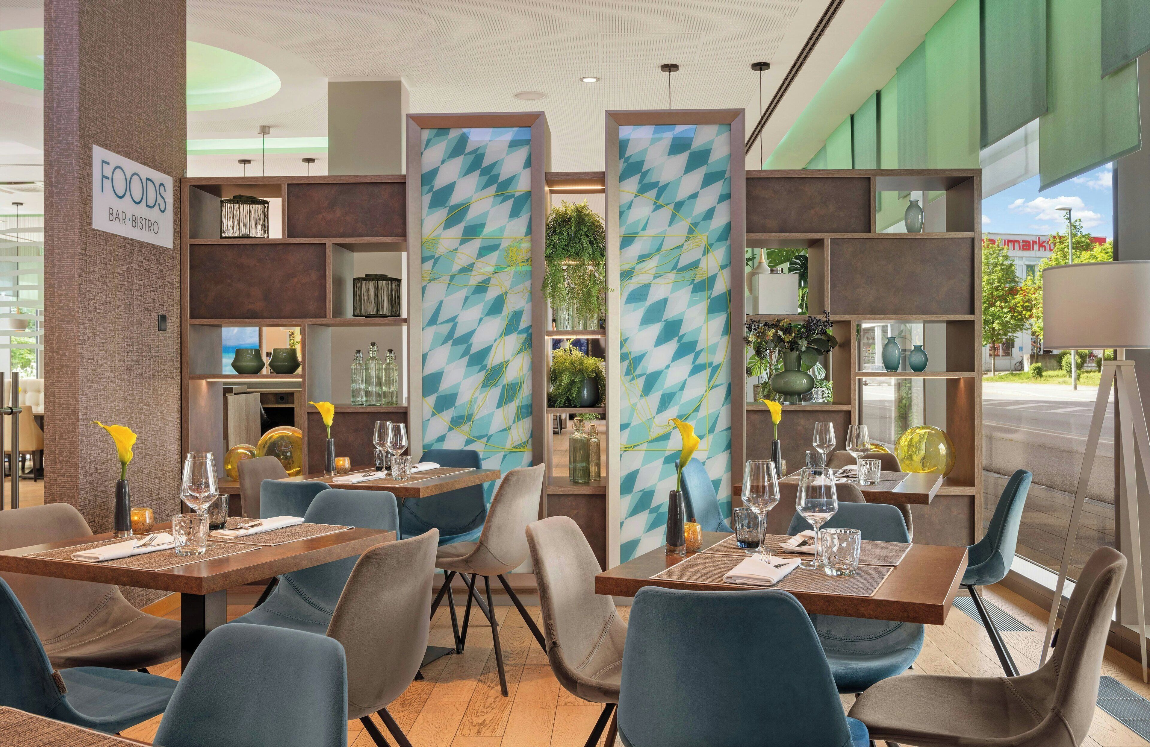 A restaurant interior with multiple tables, chairs, and a sign indicating a bar and bistro.