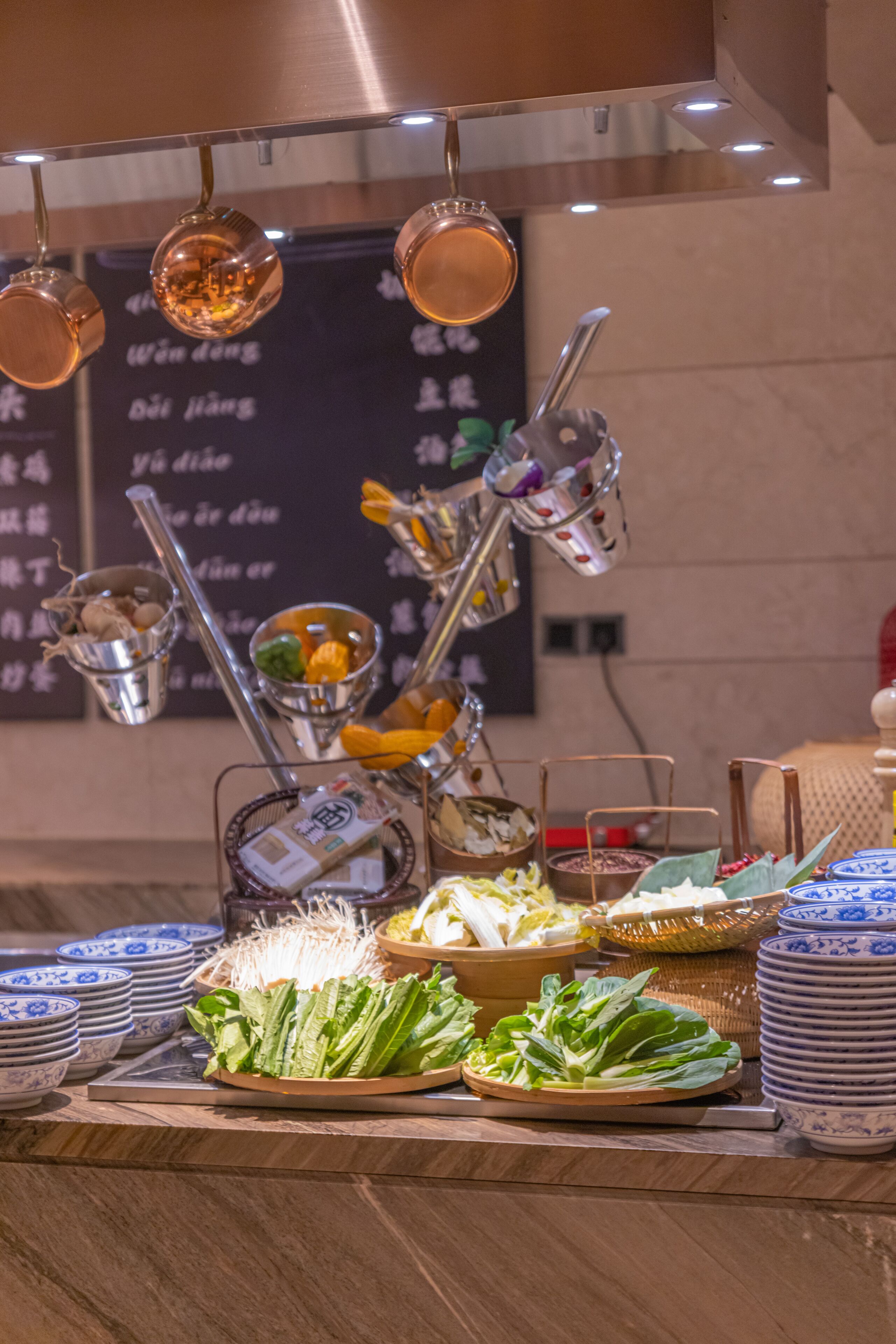 A buffet setup with various dishes and utensils.