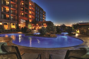 A hotel with a swimming pool, outdoor seating, and a well-lit building facade. - Courtyard by Marriott Pigeon Forge (Pigeon Forge)