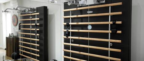 A gym with exercise equipment, including wooden bars and exercise balls.