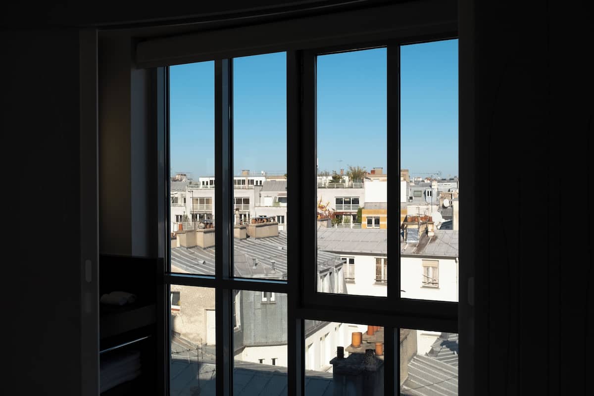A room with a large window overlooking a cityscape.