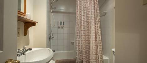 A bathroom with a bathtub, a sink, and a toilet.